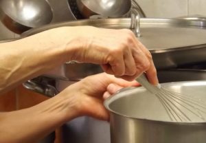 PersonWhiskingInSauepan How to Choose the Best Sauce Pans for Your Kitchen