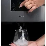 KBice Dispensing Nugget Ice Maker w:Glass Person using ice maker machine